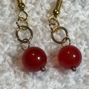 Reddish gold-color beaded earrings.